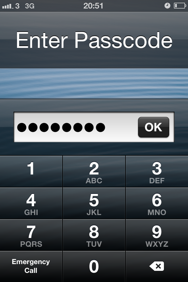 iPhone lock screen with a long passcode entered into a text field.