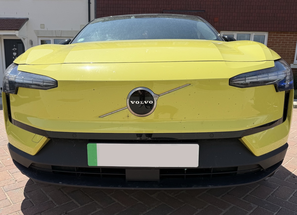 The front of the car, which has lots of small black dots covering the yellow paint.